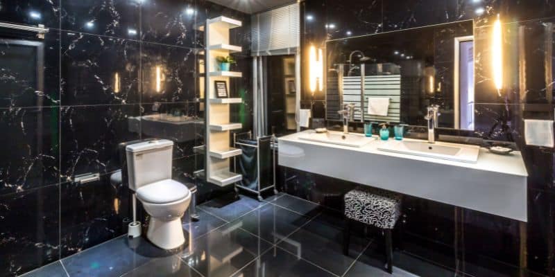 Luxurious bathroom with black marble walls and modern lighting fixtures