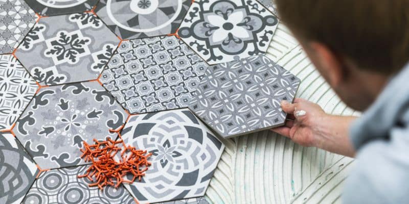 Person installing patterned tiles